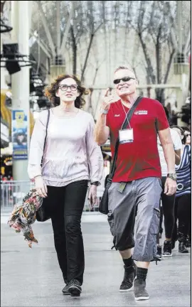  ??  ?? Beth Macmillan, executive director of Reno’s annual Artown festival, joins Urban Adventures’ Richard Hooker on Fremont Street during a 10-block cultural walking tour.