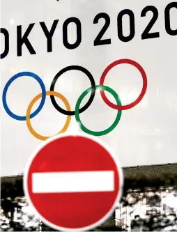  ?? (Reuters) ?? A BANNER for the now-postponed Tokyo 2020 Olympics is seen this week behind a ‘do not enter’ traffic sign in the Japanese capital.