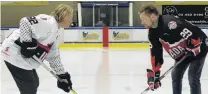  ?? PHOTO: JOSH WALTON ?? Faceoff . . . Team USA’s Michael Budd (left) on the ice at Queenstown Ice Arena with Team Canada’s Eric Neilson.