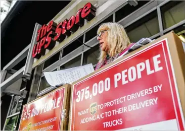  ?? JOHN SPINK/JSPINK@AJC.COM ?? Theresa Klenk announces collecting more than 375,000 online signatures Monday in front of the UPS Store in Midtown. She said her husband, 59, a UPS driver in New Jersey, suffered heat stroke in August 2016.