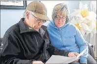  ?? MITCH MACDONALD/GUARDIAN FILE PHOTO ?? Kent King and Patti King look over a document containing informatio­n about the proposed Three Rivers amalgamati­on and how it would affect residents of Burnt Point and Georgetown Royalty last December.