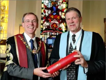  ??  ?? Kenneth Mealy, President of the Royal College of Surgeons presenting Wexford Festival Opera’s departing Artistic Director David Agler with an Honorary Fellowship.