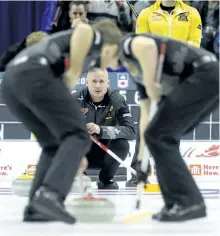  ?? ADRIAN WYLD/THE CANADIAN PRESS ?? Team Koe lead Ben Hebert and third Marc Kennedy sweep as skip Kevin Koe, from Calgary, Alta., watches a shot approach the house during Roar of the Rings Olympic Curling Trials action in Ottawa on Sunday, Dec. 10.