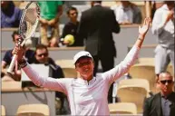  ?? Michel Euler / Associated Press ?? Iga Swiatek celebrates winning her third-round match against Danka Kovinic in two sets, 6-3, 7-5, at the French Open on Saturday.
