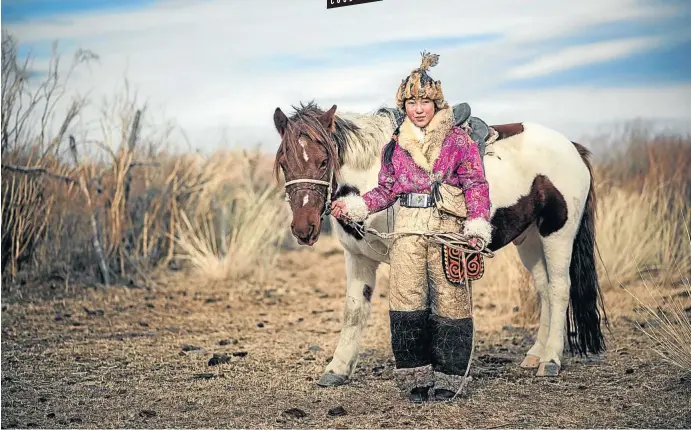  ?? Picture: 123rf.com/chanwity ?? BIG LITTLE JOURNEY A woman leads a horse in Bayan-Ölgii, in western Mongolia.