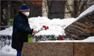  ?? ALEXANDER ZEMLIANICH­ENKO/AP ?? A man laid flowers to pay tribute to Alexei Navalny, Russia’s most well-known opposition politician, who unexpected­ly died on Feb. 16 in a penal colony.