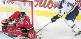  ?? CALGARY HERALD/ FILES ?? The Calgary Flames are looking to goaltender Jonas Hiller, seen stopping Chris Porter’s shot during a March 17 game against the Blues, to start in net Thursday in St. Louis.
