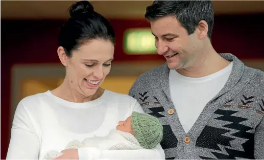  ??  ?? Neve Te Aroha Ardern Gayford with her parents, Jacinda Ardern and Clarke Gayford (in his ‘‘dad cardie’’), at a press conference at Auckland City Hospital yesterday, before the family went home. ABIGAIL DOUGHERTY/STUFF
