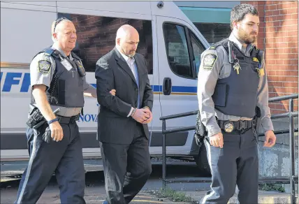  ?? HARRY SULLIVAN   TRURO NEWS ?? Ernie (Junior) Duggan is seen being led into Nova Scotia Supreme Court in Truro to set dates for his  rst-degree murder trial in the death of his Bayhead neighbour Susan Butlin.