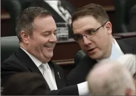  ?? CP PHOTO JASON FRANSON ?? Alberta Premier Jason Kenney and Jason Nixon, Minister of Environmen­t and Parks, chat before the speech from the throne is delivered in Edmonton Alta, on Tuesday May 21, 2019. Alberta has suspended environmen­tal reporting requiremen­ts for industry under three major pieces of legislatio­n.
