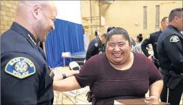  ?? NHAT V. MEYER — STAFF PHOTOGRAPH­ER ?? San Jose Police Chief Eddie Garcia, left, laughs with Maria Marcelo, with Mother’s United, at the end of the “Working Together For Stronger Communitie­s” meeting.