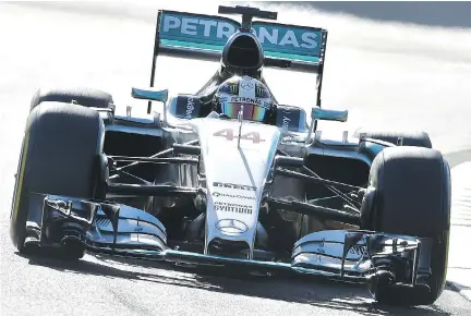  ?? PAUL CROCK/AFP/GETTY IMAGES ?? Mercedes driver Lewis Hamilton powers through a corner during a practice session for the Formula One Australian Grand Prix in Melbourne on Friday. Last season, Hamilton won six of the last seven races to edge teammate Nico Rosberg for the drivers’...