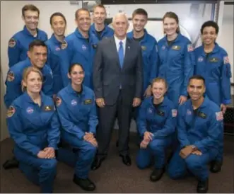  ??  ?? Vice President Mike Pence poses for a group photograph with NASA’s 12 new astronaut candidates Wednesday at NASA’s Johnson Space Center in Houston, Texas.