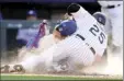  ?? AP photo ?? The Rockies’ C.J. Cron and Dodgers catcher Austin Barnes collide as Cron scores on a wild pitch.