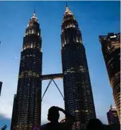  ?? BLOOMBERG PIC ?? Standard Chartered Bank has lowered its forecast for Malaysia’s gross domestic product growth this year to 4.8 per cent due to the United StatesChin­a trade spat.