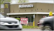  ?? KEITH SRAKOCIC — THE ASSOCIATED PRESS ?? A hiring sign offers a $500bonus outside a McDonalds restaurant last week in Cranberry Township, Butler County, Pa.