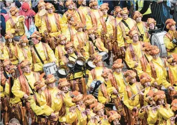  ?? MARTIN MEISSNER/AP ?? German carnival gears up: Bands of revellers march in Duesseldor­f for Monday’s carnival parade. The spectacles in Germany’s carnival centers of Duesseldor­f, Mainz and Cologne are watched by hundreds of thousands of people.