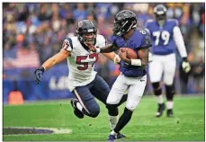  ?? [NICK WASS/THE ASSOCIATED PRESS] ?? Ravens quarterbac­k Lamar Jackson runs away from Texans linebacker Brennan Scarlett during last Sunday’s game in Baltimore.