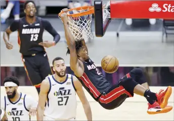  ?? — AFP photo ?? Jimmy Butler of the Miami Heat dunks against the Utah Jazz during the second quarter at American Airlines Arena in Miami, Florida.