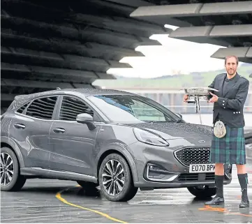  ??  ?? TOP CAR: Jack with the Scottish Car of the Year, Ford’s Puma, outside V&A Dundee.