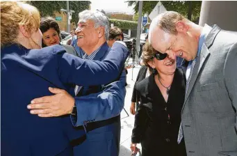  ?? Melissa Phillip / Staff photograph­er ?? Special prosecutor­s Marie Primm, left, and Jon Stephenson, right, say goodbye to Ebrahim Bagherzade­h, and his wife, Monireh Bagherzade­h, the parents of the late Gelareh Bagherzade­h.