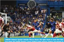  ?? — AFP ?? LONDON: Chelsea’s Spanish defender Marcos Alonso (4th right) shoots to score their third goal during the English Premier League football match between Chelsea and Arsenal at Stamford Bridge in London yesterday.