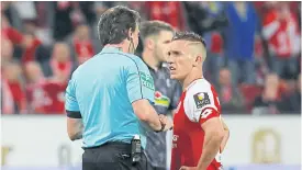  ??  ?? Mainz’s Pablo De Blasis speaks with referee Guido Winkmann before taking his penalty against Freiburg during a Bundesliga match.