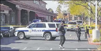  ?? Michael Quine Las Vegas Review-Journal ?? Police investigat­e an officer-involved shooting at the Green Valley Plaza shopping center Saturday on Green Valley Parkway near Sunset Road in Henderson.