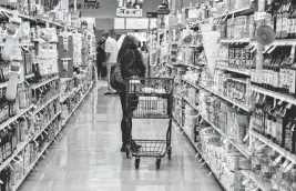  ?? JASON ARMOND Los Angeles Times ?? A shopper visits Albertsons in Los Angeles earlier this year. Kroger plans to buy Albertsons — which owns Safeway and other brands — in a deal valued at $24.6 billion, but government regulators want to stop the biggest proposed supermarke­t merger in U.S. history.