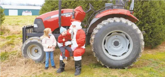  ??  ?? Lily Shelton, 5, of Bethlehem, and her 2-year-old brother, Keegan, visit with Santa on Saturday at Seiple Farms.