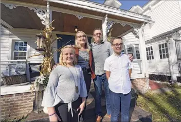  ?? Photos by Lori Van Buren / Albany Times Union ?? From left, Harmony, Sarah, John and Joshua Trop stand outside their historic home in Wynantskil­l. Sarah and John Trop bought the home with a goal of restoring it.