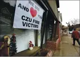  ?? SHMUEL THALER — SANTA CRUZ SENTINEL ?? Signs of love and support for victims of the CZU August Lightning Complex fires fills a storefront window in downtown Boulder Creek.