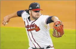  ?? Tony Gutierrez The Associated Press ?? Braves rookie pitcher Bryse Wilson limited the Dodgers to one hit in six innings to help Atlanta to a 10-2 win Thursday night and a 3-1 lead in the NLCS.