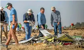  ?? AP ?? Foreign investigat­ors examine wreckage at the scene where the Ethiopian Airlines Boeing 737 Max 8 crashed shortly after takeoff, killing all 157 people on board.