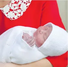  ??  ?? Prince William and Kate, Duchess of Cambridge, leave St. Mary’s Hospital in London on Monday with their newborn son, now fifth in line to the throne.