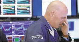  ?? RICHARD DREW/AP ?? Specialist John O’Hara works on the floor of the New York Stock Exchange as stocks slumped for a second straight day. The market, which is enduring its most volatile stretch since February, sank by more than 2 percent. The Dow dropped 546 points after dropping 831 points on Wednesday.