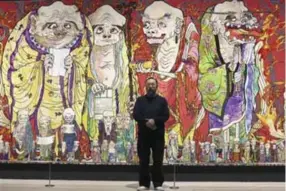  ??  ?? Japanese artist Takashi Murakami poses in front of part of his work titled “The 500 Arhats” exhibited at Mori Art Museum in Tokyo.—AP photos