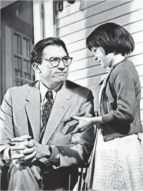  ?? JOHN SPRINGER COLLECTION ?? Gregory Peck embodies paternal strength as Atticus Finch, father of Scout, played by Mary Badham, in “To Kill a Mockingbir­d.”
