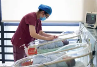  ?? ?? A nurse takes care of newborns at a hospital in Nanjing, Jiangsu Province, on September 30, 2023