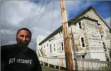  ?? DAVID GOLDMAN — THE ASSOCIATED PRESS ?? Robert LaCount, a recovering addict, stands outside an old church he is fixing up as a community center in Hoquiam, Wash., Monday. For years, LaCount cycled in and out of jail and it did nothing to stop the addiction. He didn’t care if he lived or...