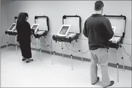  ?? [JOSHUA L. JONES/ATHENS BANNER-HERALD] ?? Georgia residents cast votes in a runoff election for statewide races in 2018. A federal judge has ordered Georgia election officials to allow computer experts and lawyers to review the databases used to create ballots and count votes.