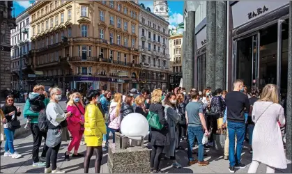  ??  ?? BACK IN LINE: Shoppers, many wearing masks, queue outside a branch of Zara as the lockdown is lifted in Vienna