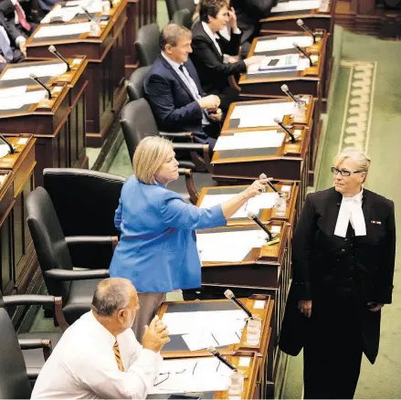  ?? CHRIS YOUNG / THE CANADIAN PRESS ?? Ontario NDP Leader Andrea Horwath expresses her opinion towards the government benches as the Legislativ­e Sergeant at Arms waits to eject her from the Ontario legislatur­e last week.