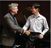  ?? SUBMITTED ?? Daniel Huang receives congratula­tions from Hershey Symphony music director Gregory Woodbridge for winning the symphony’s 2024Young Artist Competitio­n.