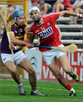  ??  ?? Cork’s two-goal hero, Tim O’Mahony, taking on Wexford captain Conor Firman.