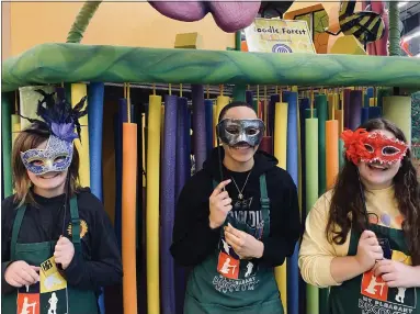  ?? PHOTO PROVIDED BY THE MT. PLEASANT DISCOVERY MUSEUM. ?? Diamond Cotton, Meghan Welker and a volunteer wear masquerade masks, which will be set up at the photo booth.