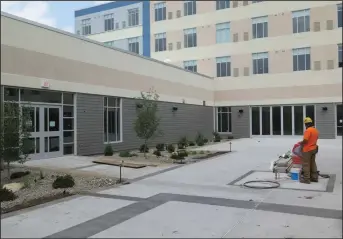  ?? Joseph B. Nadeau photos ?? At left, as part of the Twin River Casino hotel project, finishing touches are being put on the courtyard event space. Below, assistant project manager Mark Gabrielle says this indoor pool isn’t quite bathing suitready, but will be by the time the hotel officially opens.