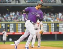  ?? Andy Cross, The Denver Post ?? Carlos Gonzalez, circling the bases last week after hitting a home run against the Astros, has refound his swagger after getting into a hot streak.