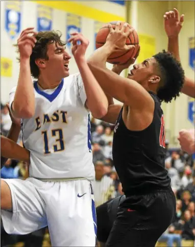  ?? PETE BANNAN — DIGITAL FIRST MEDIA ?? Downingtow­n East’s Jarred Desrocher tries to defend against Coatesvill­e’s Tione Holmes Tuesday night.