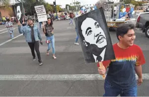  ?? MICHAEL CHOW/THE REPUBLIC ?? Members of Gateway Bible Church march during a parade honoring Martin Luther King Jr. in Mesa on Jan. 20, 2020.